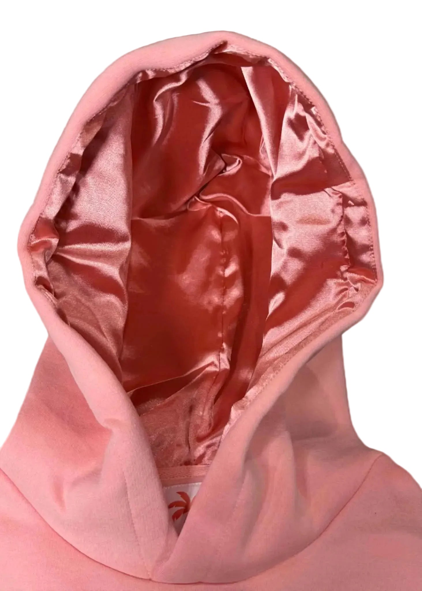 Close-up of a pink hooded garment with a textured background